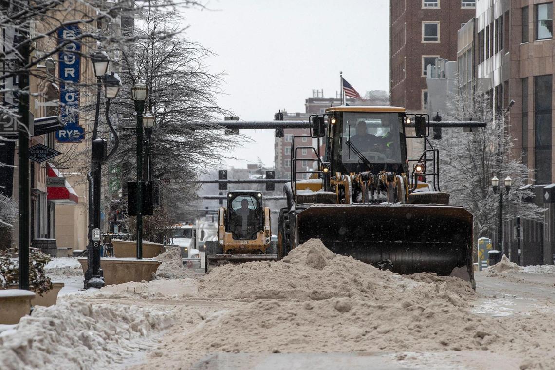Workers cleared snow from Main Street in Lexington Tuesday.