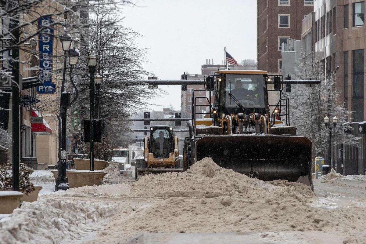 Workers cleared snow from Main Street in Lexington Tuesday.