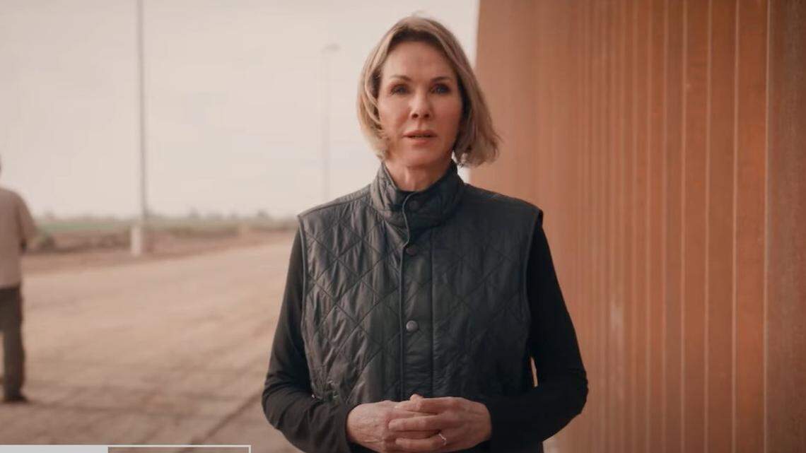 GOP candidate for governor Kelly Craft stands in front of a section of the U.S.-Mexico border wall in her latest television ad.
