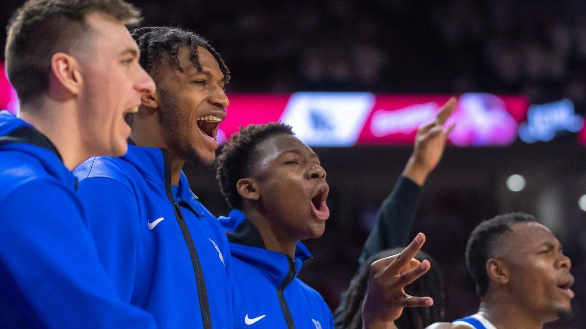 From left, Kentucky bench players Brennan Canada, Daimion Collins and Adou Thiero cheer on their teammates during UK’s win over Arkansas on Saturday.