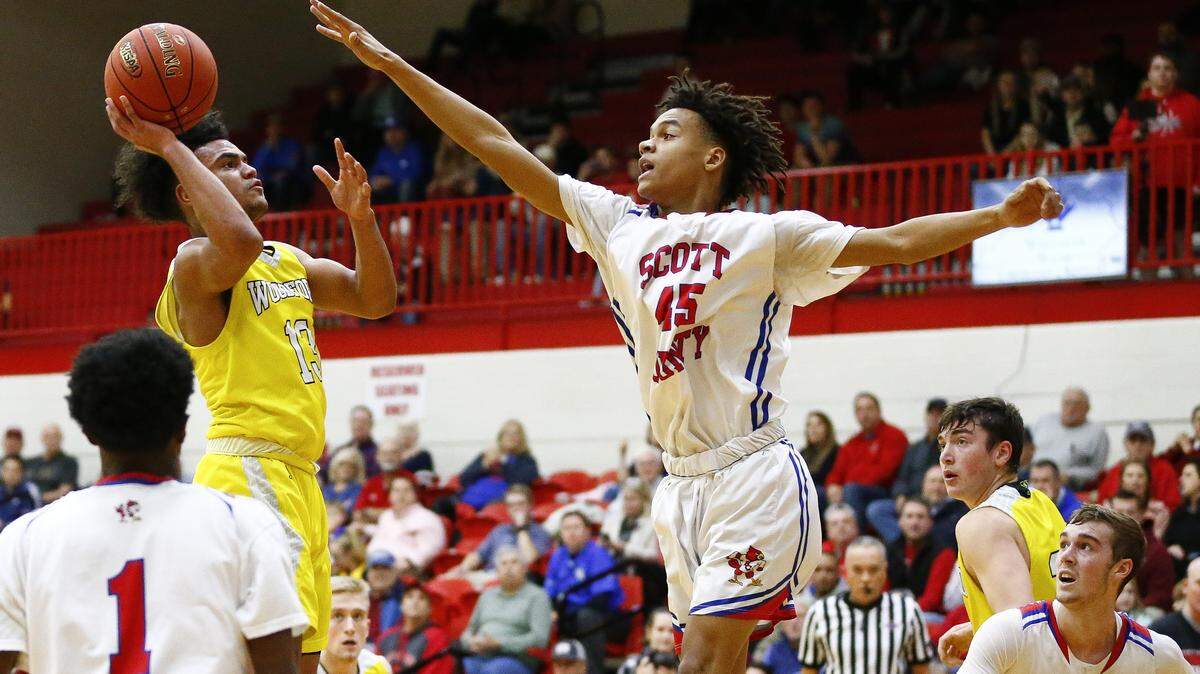 Woodford County’s Anthony Tabor (13) shot against Scott County’s Kobi Harris (45) during their game Thursday at Scott County High School in Georgetown. Scott County beat Woodford County 93-56.