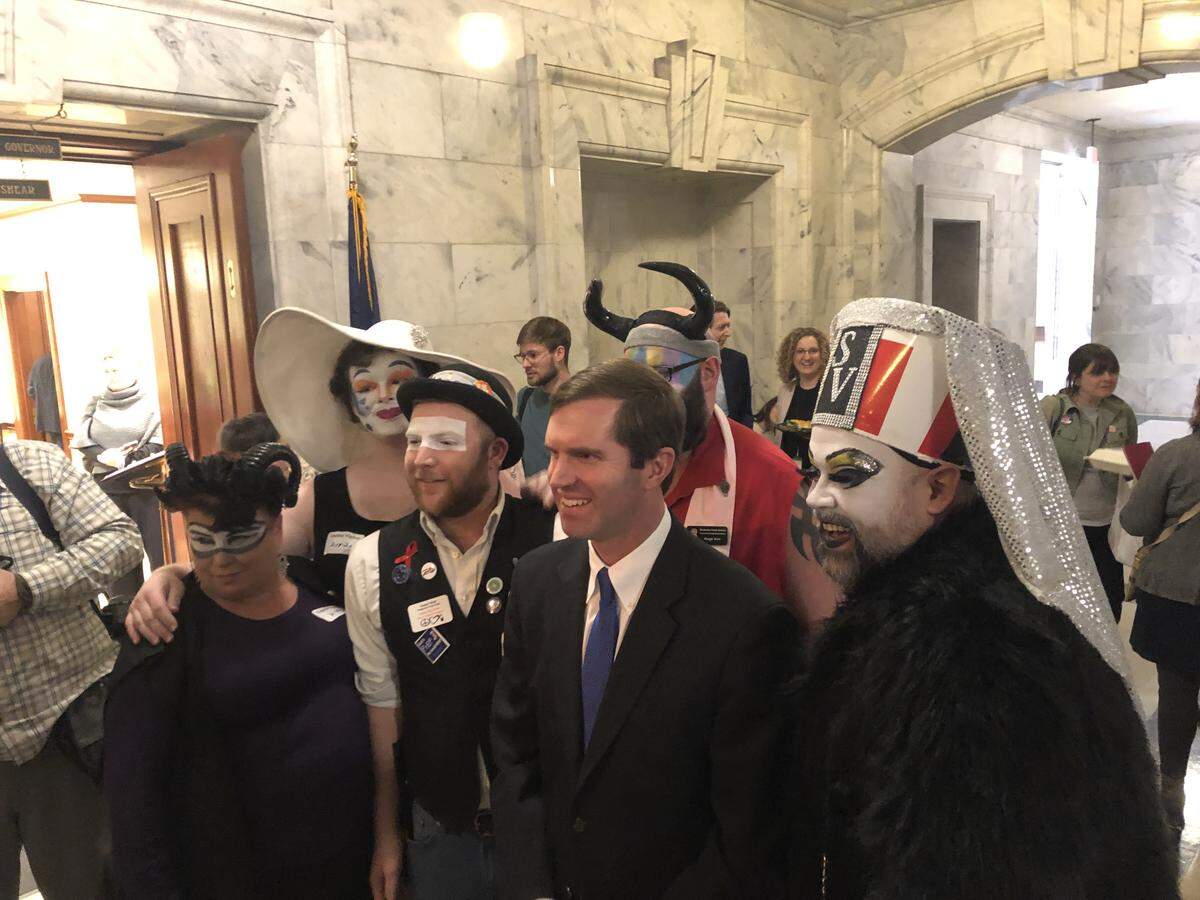 Gov. Andy Beshear poses with representatives from the Kentucky Order of the Sisters of Perpetual Indulgence, an LGBTQ charity group that uses performance art and drag to raise money for charity.