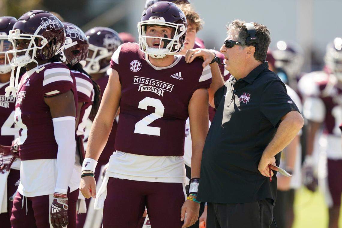 Mississippi State head coach Mike Leach confers with Mississippi State quarterback Will Rogers (2) during the first half of an NCAA college football game in Starkville, Miss., Saturday, Oct. 8, 2022. Mississippi State won 40-17. (AP Photo/Rogelio V. Solis)