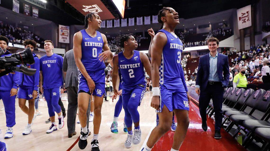 Kentucky Wildcats forward Jacob Toppin (0) Kentucky Wildcats guard Sahvir Wheeler (2) and Kentucky Wildcats guard TyTy Washington Jr. (3) celebrate after defeating Texas A&M Aggies 64-58 at Reed Arena in College Station, Texas, Wednesday, Jan. 19, 2022.