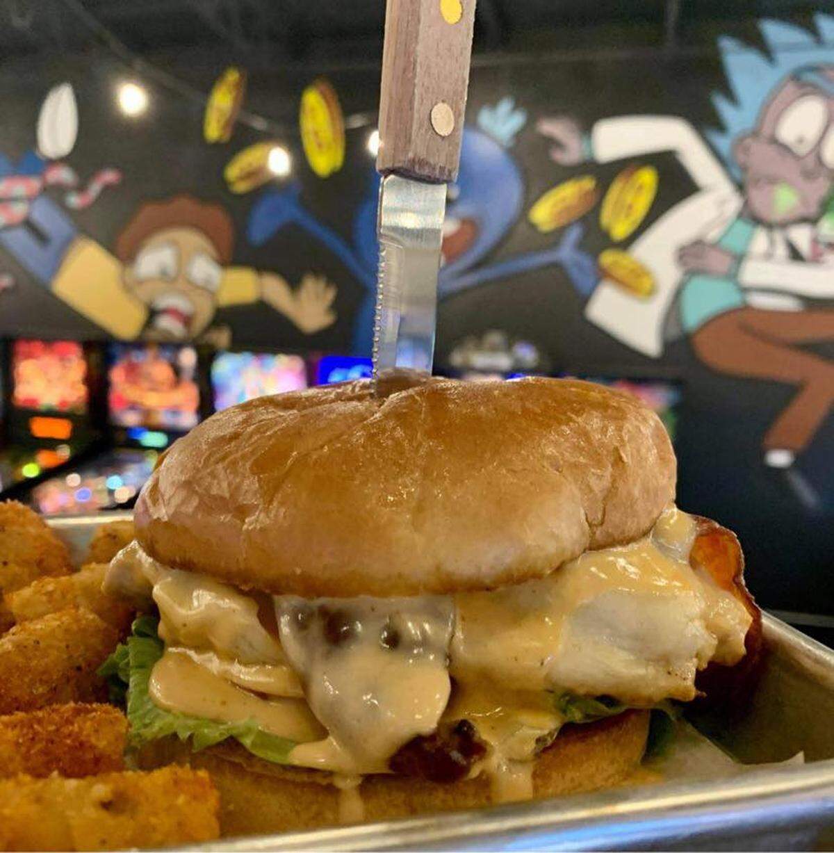 The Cluck Yeah at Louisville’s Recbar is a grilled chicken breast with melted Swiss, bacon sriracha ranch, lettuce, tomato and a potato bun. The bar also has pinball machines and video games, and Tilty Bob’s in Lexington will too.