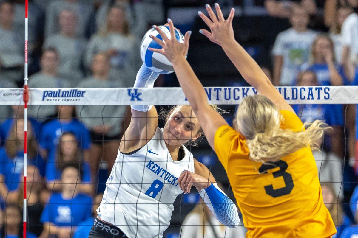Kentucky’s Brooke Bultema (8) hits the ball over the net as Northern Kentucky’s Ava Hoying defends during a volleyball match at the newly renovated Memorial Coliseum on Friday.