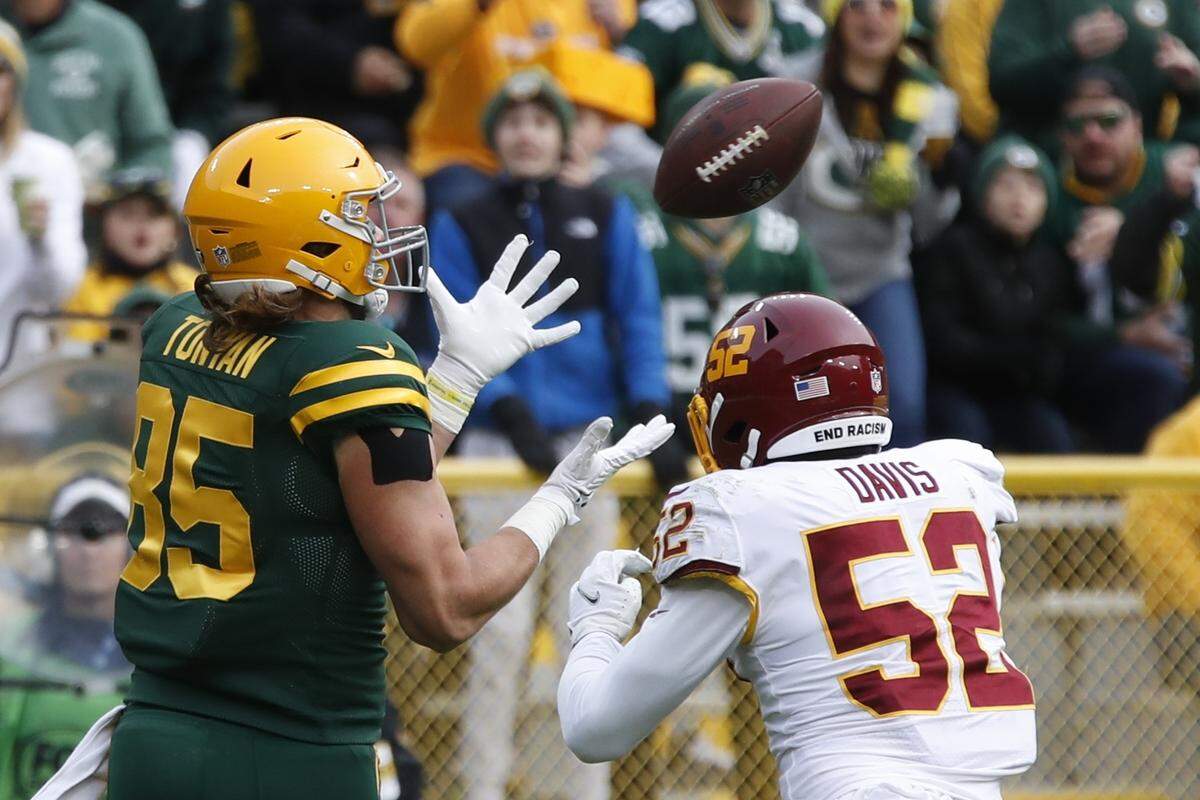 Green Bay’s Robert Tonyan catches a touchdown pass in front of Washington’s Jamin Davis last Sunday, a play that demonstrated the rookie’s inexperience diagnosing plays at the line of scrimmage.