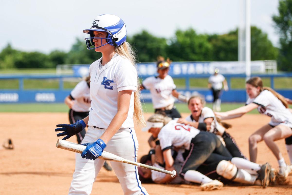 Lexington Catholic’s Lydia Kennedy walks off the field as Ballard celebrates winning the state softball championship game at John Cropp Stadium on Sunday.
