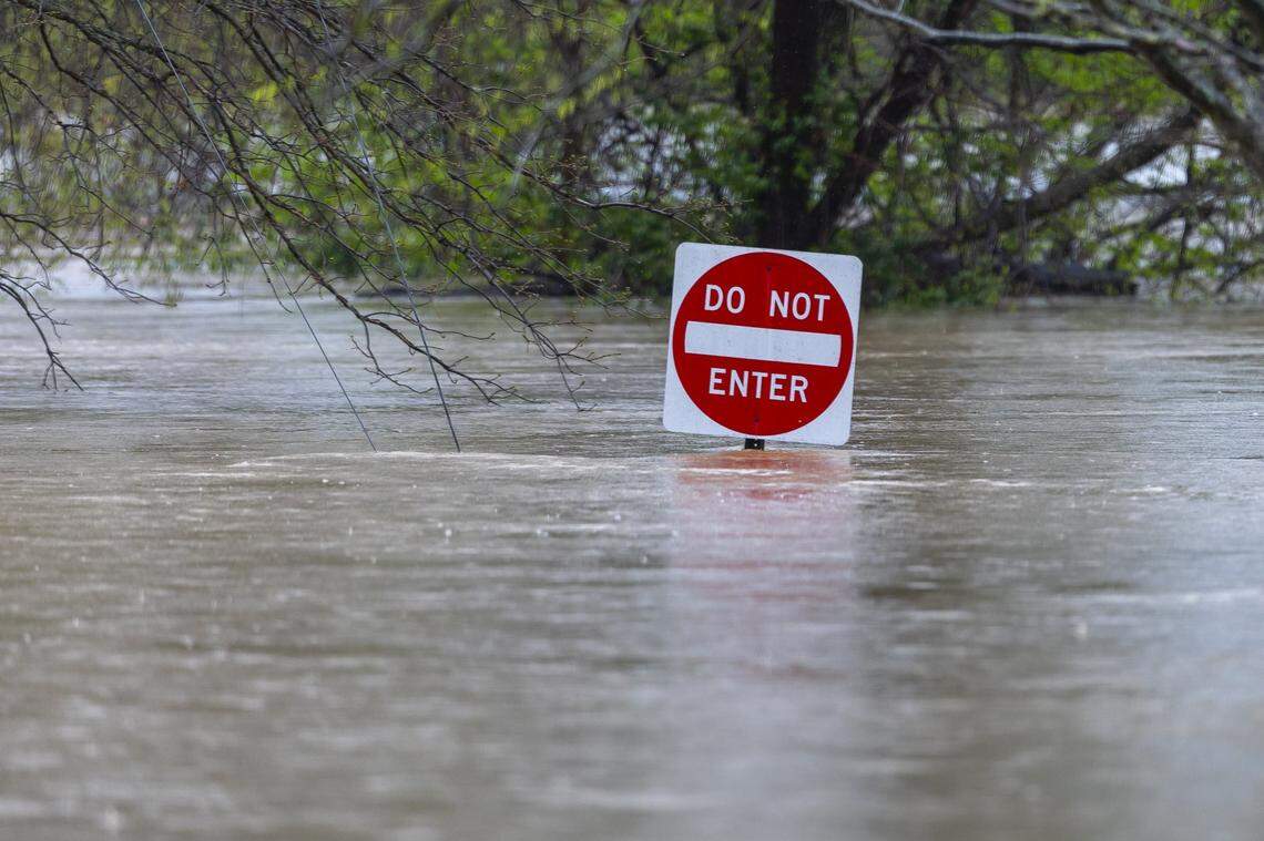 The Kentucky River floods the Paul Sawyier Public Library parking lot in downtown Frankfort, Ky., on Saturday, April 5, 2025.