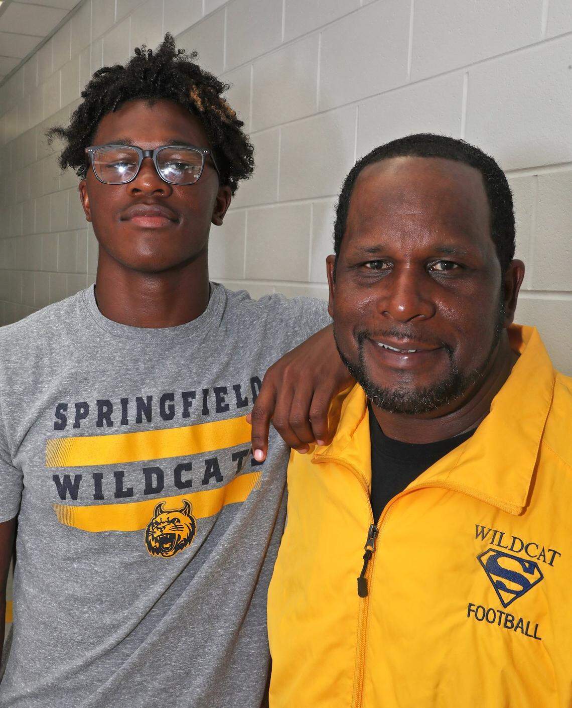 Moses Douglass, left, followed the footsteps of his father, Maurice Douglass, and played football at the University of Kentucky.