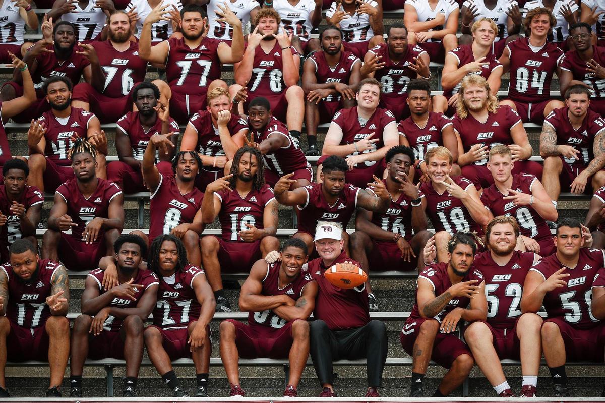 Eastern Kentucky University football coach Walt Wells, bottom row center right, poses with linebacker Matthew Jackson (33) during a team picture during media day at Roy Kidd Stadium in Richmond, Ky., Tuesday, Aug. 10, 2021. Jackson was named to the FCS All-America Second Team after the 2020 season, and was an FCS Preseason All-America Third Team selection ahead of the 2021 season.