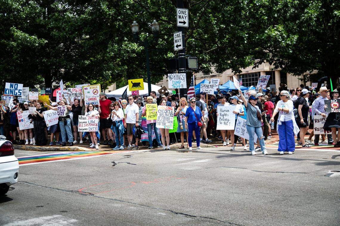 Protesters lined the streets as cars passed by honking horns in solidarity during the “No Kings” protest of President Donald Trump’s administration on Saturday, June 14, 2025, in downtown Lexington, Ky.