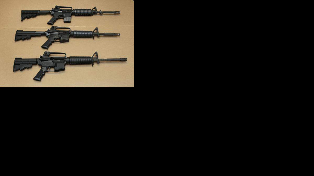 In this Aug. 15, 2012 file photo, three variations of the AR-15 assault rifle are displayed at the California Department of Justice in Sacramento, Calif. 