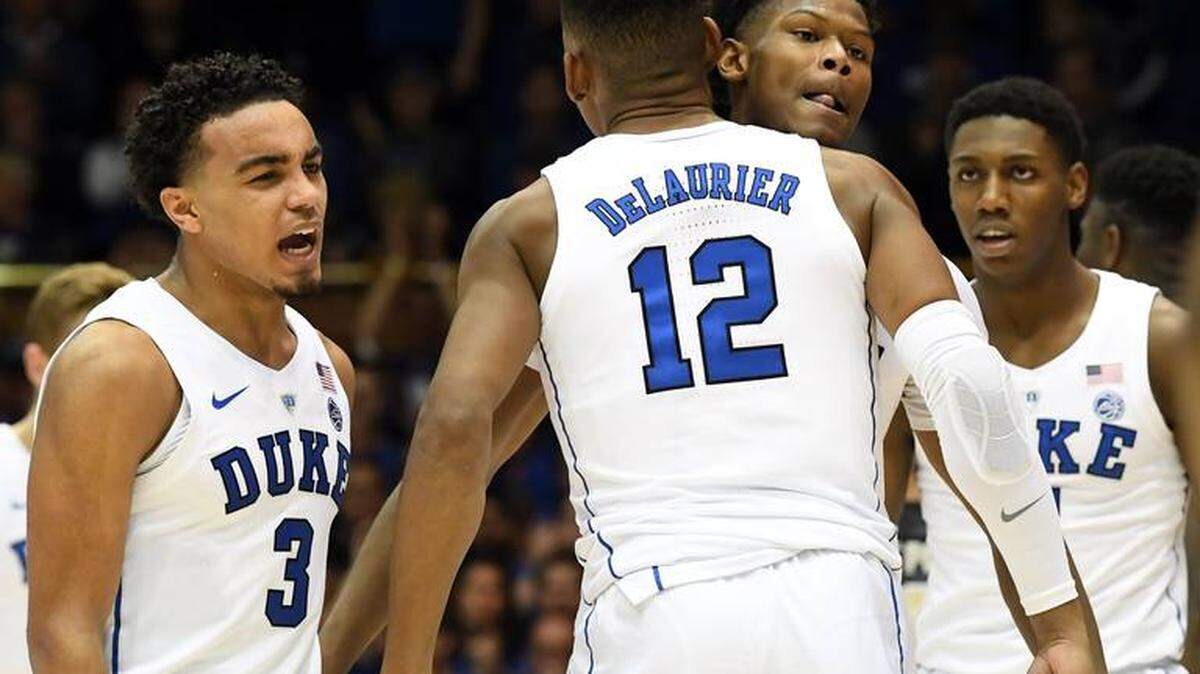 Duke forward Cam Reddish (2) gets congratulated for a three pointer by forward Javin DeLaurier (12) as the team heads to the bench during a second half timeout. Duke defeated Army 94-72 at Cameron Indoor Stadium In Durham, N.C. Sunday, Nov. 11, 2018.