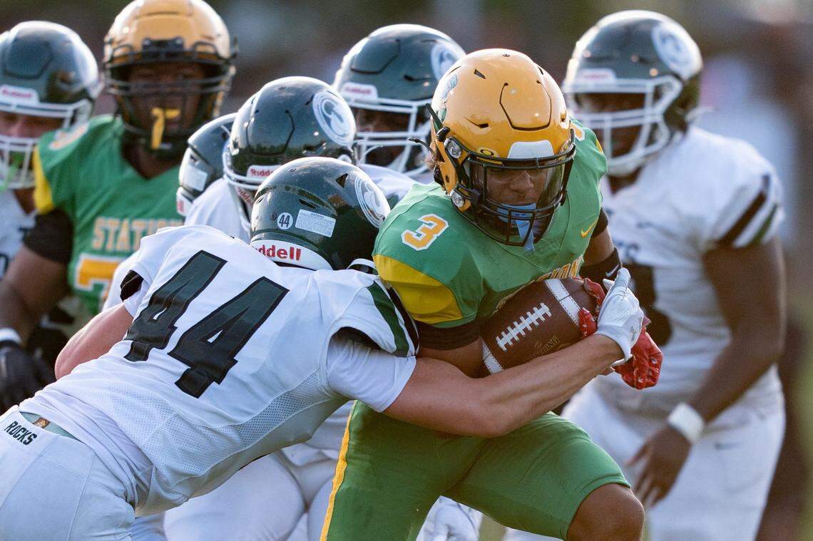 Trinity's Nick Lococo (44) tackles Bryan Station's Jordan Haskins (3) during their game on Friday, Aug. 23, 2024 at Bryan Station High School in Lexington, Ky.