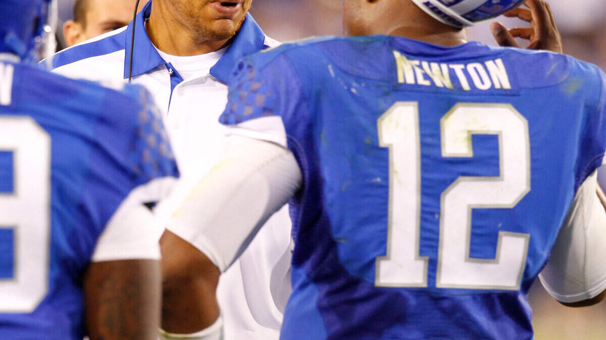 UK graduate assistant coach Andre Woodson talked to Kentucky quarterback Morgan Newton during the loss to Louisville. As a senior starter at QB for the Cats in 2007, Woodson helped lead Kentucky to a 43-37 triple-overtime win over LSU, UK's opponent on Saturday. "We always knew that we had the ability to come back. We relied on each other. We never lost faith," Woodson said.      