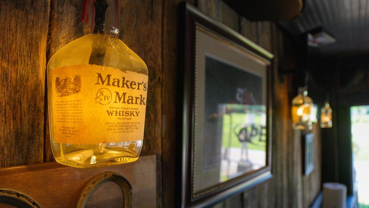 A Maker’s Mark bottle converted into a lamp is part of the horse and bourbon theme at Golden’s Pub & Deli.