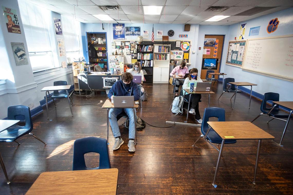 Macy Dungan, second from left, a senior at Frankfort High School in Frankfort, Ky., takes a quiz in her math class on Monday, Feb. 8, 2021, the first day senior students were allowed to attend in-person classes at the school in nearly a year.