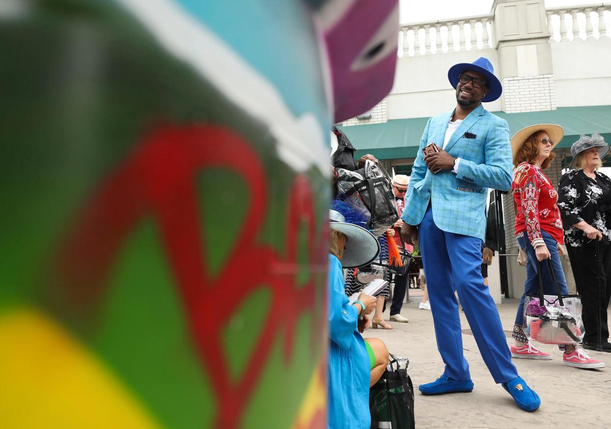 Marcus Bailey, from Dallas, wears a custom-made outfit in blue from Q Clothier at Churchill Downs in Louisville, Ky., Saturday, May 7, 2022.