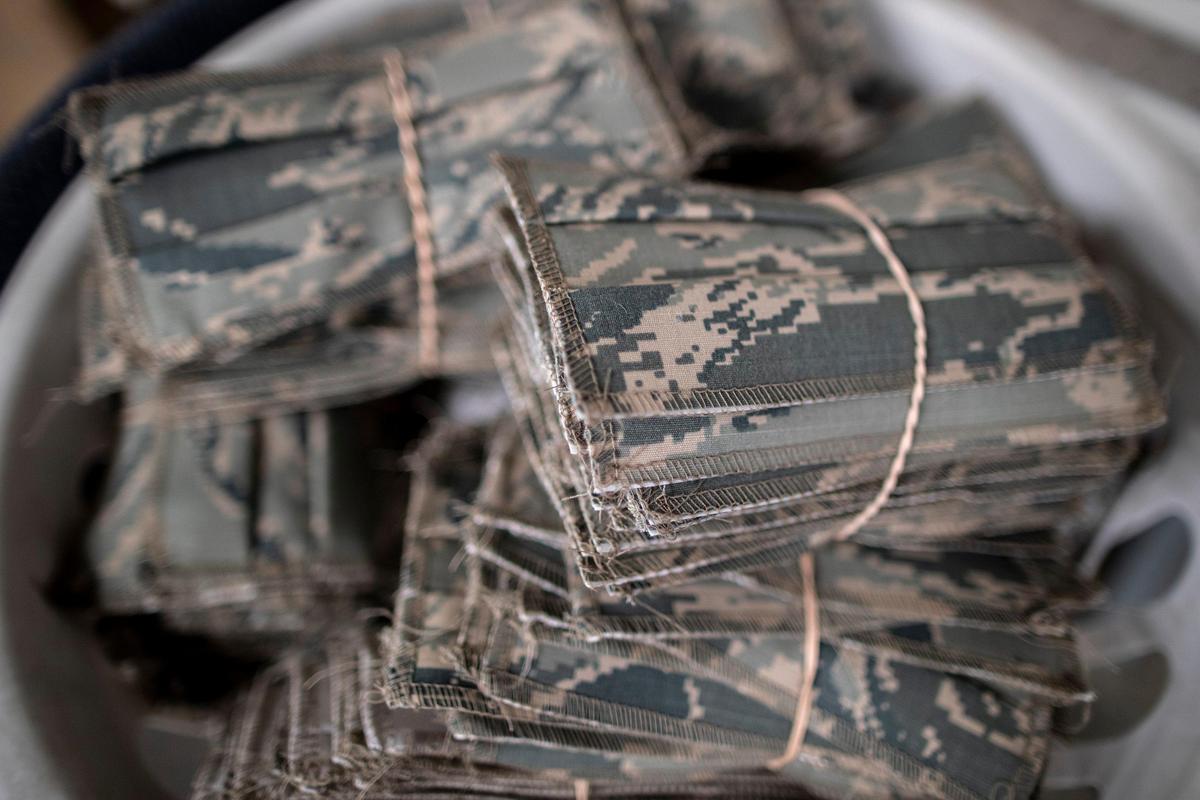Bundles of completed face masks are stacked in a bin at Southeast Kentucky Rehabilitation Industries in Corbin, Ky., on Monday, March 30, 2020. The non-profit corporation, which makes sewn products for the U.S. military, has begun producing protective masks for the Kentucky state government.