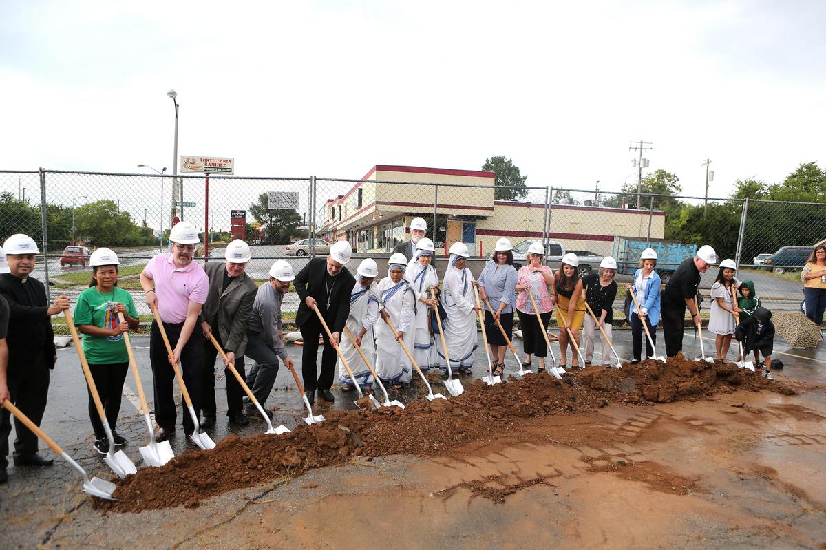 Supporters turned soil Tuesday morning during a ceremonial groundbreaking for the Hispanic Center in Lexington, to be constricted at the intersection of Alexandria and Devonport. Photo by Matt Goins
