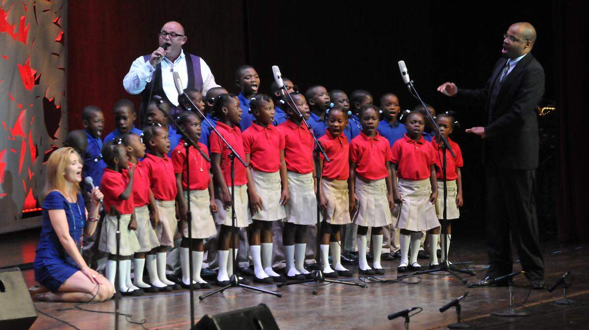 The Chieftains singers Ronan Tynan (back) and Alyth McCormack (kneeling) sang Amazing Grace with the Haitian Harmony children's choir during 
a benefit concert Monday night for the earthquake-ravaged country.  