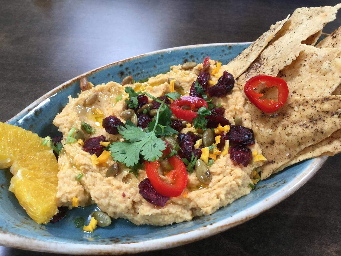 The butternut squash hummus comes dressed with dried cranberries, pumpkin seeds, fresh orange, fresno chili and herbs, with lavash bread to scoop it up.
