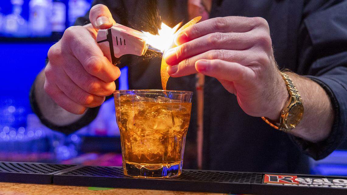 And old fashioned cocktail is made at The Cork, Thursday, Dec. 4, 2025 in Lexington, Ky. The new owner plans to bring a new food menu as part of the changes. 