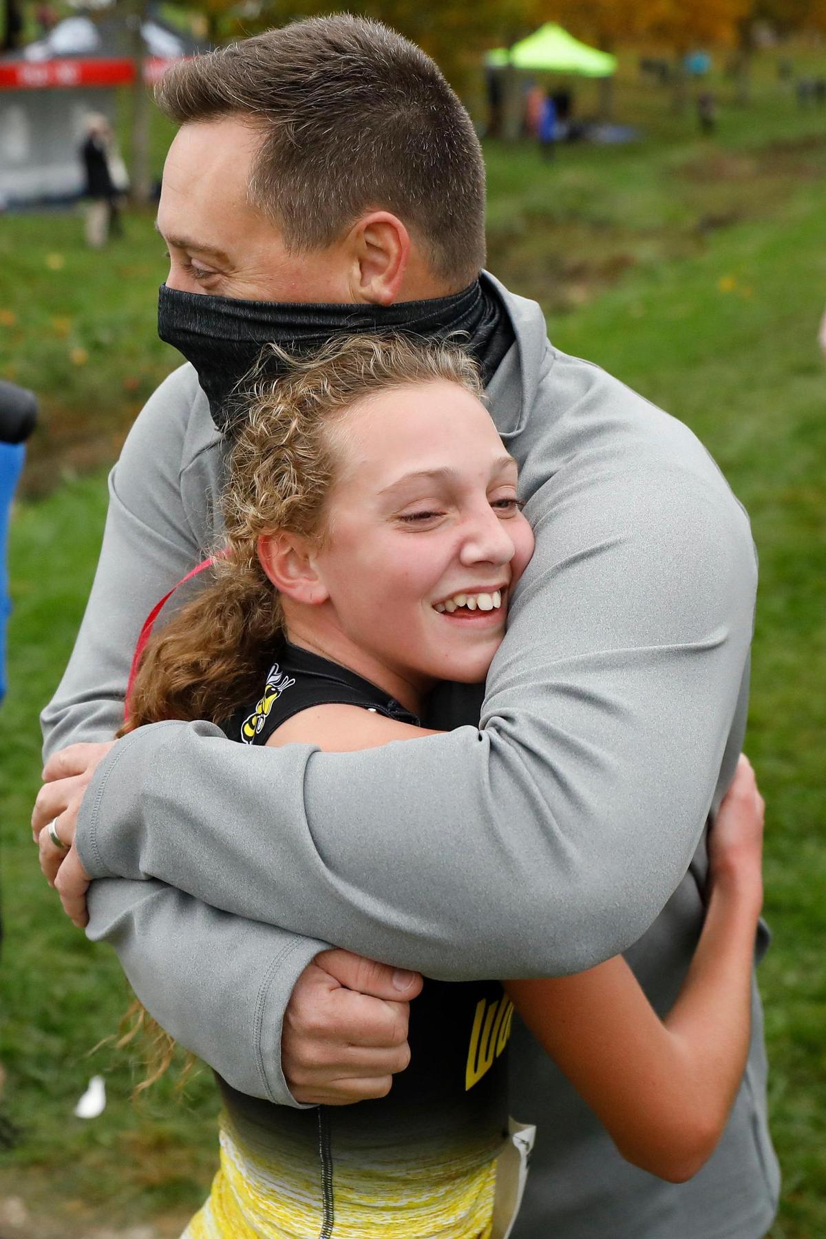 Woodford County’s Addison Moore hugged her father, Marc Moore, after she won the Class 3A Region 6 cross country meet at Lykins Park in Winchester.