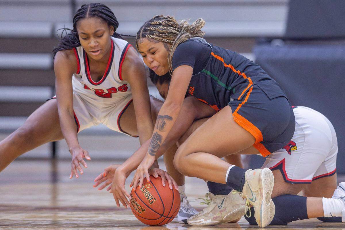 George Rogers Clark’s Teigh Yeast, left, and Makili Tabor fight for the ball with Frederick Douglass’ Niah Rhodes, right, during a game in Winchester on Dec. 15, 2023.