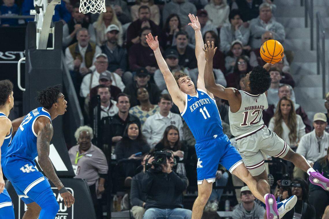 Kentucky guard Travis Perry (11) defends Mississippi State guard Josh Hubbard (12) during Saturday’s game at Humphrey Coliseum in Starkville, Miss.