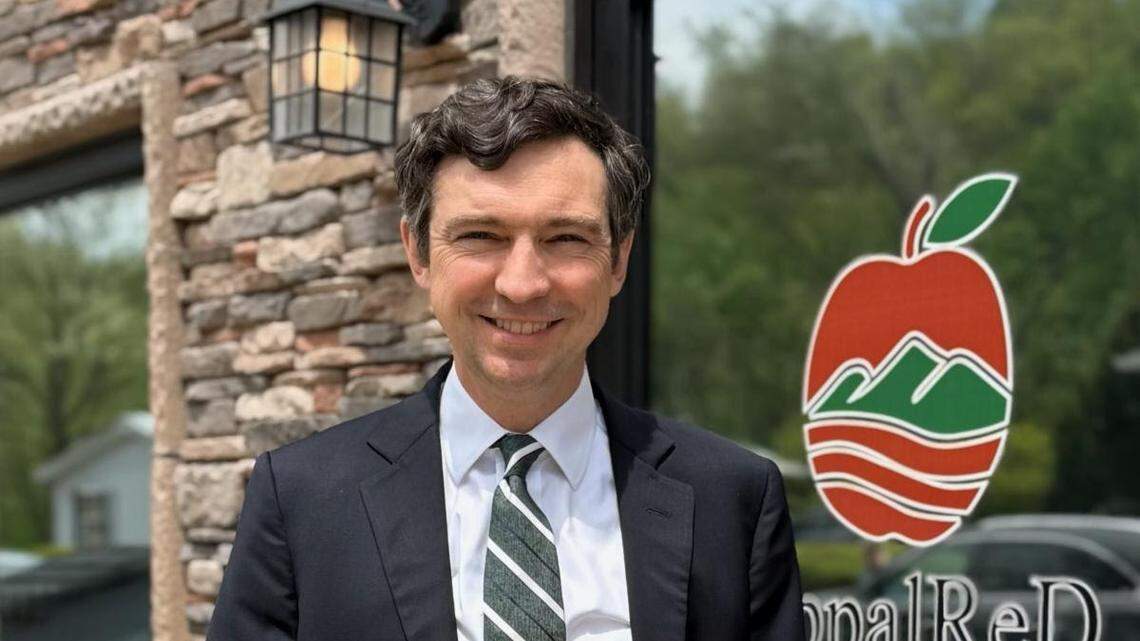 Evan Smith, advocacy director for AppalReD holding the Supreme Court brief outside his Prestonsburg office.