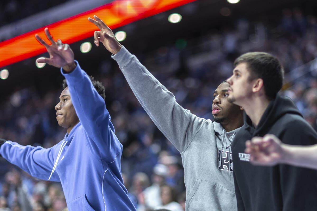 Kentucky guards Jaxson Robinson, left, Lamont Butler and Kerr Kriisa react during Wednesday’s game against Vanderbilt at Rupp Arena.