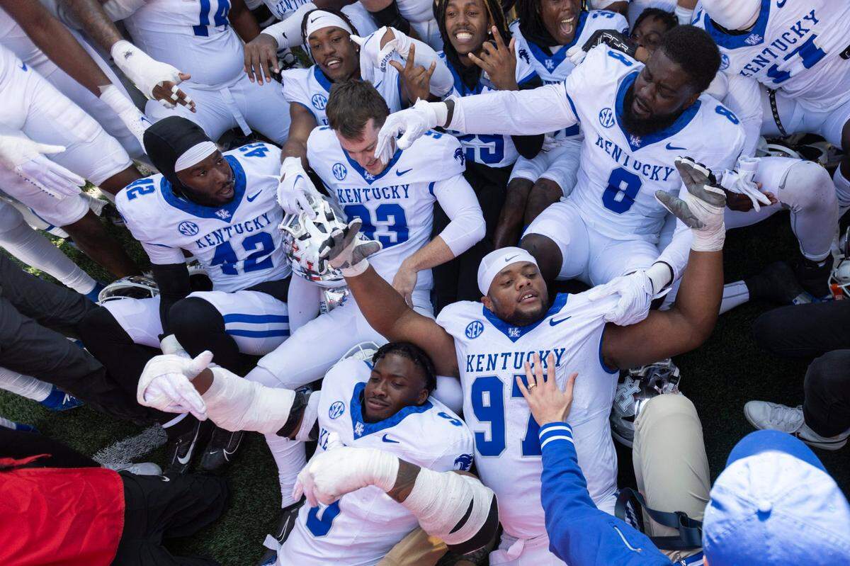 Kentucky players celebrate after defeating the Louisville Cardinals to win the Governor’s Cup for the fifth year in a row on Saturday.