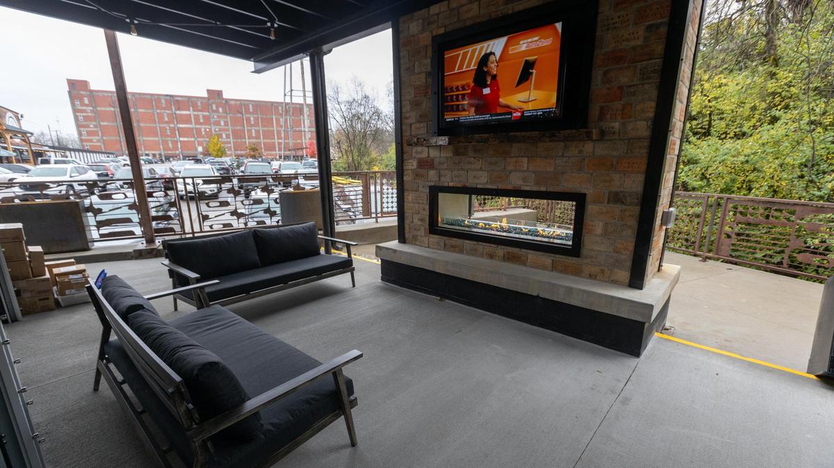 Patio space of the new building at Desperados Cantina has a vintage gas station vibe. The covered porch with the fireplace overlooks the creek.