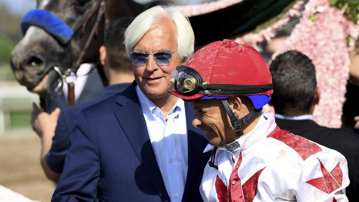 Jockey Mike Smith, right, stands next to trainer Bob Baffert after Roadster’s win in the Santa Anita Derby horse race at Santa Anita in Arcadia, Calif., Saturday, April 6, 2019.