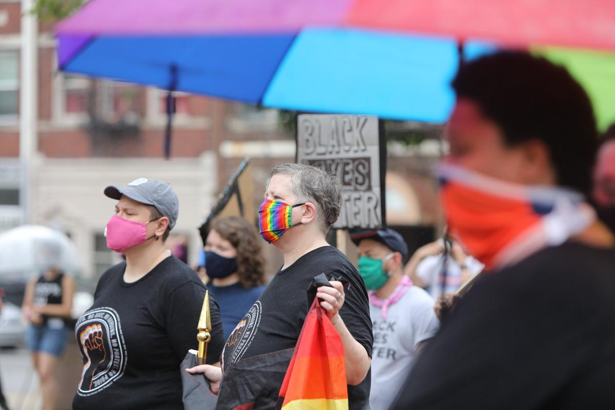 Maggie Brewer, left, and Shannon Sampler-Collins, center, listened to a speaker Saturday during a protest in downtown Lexington.