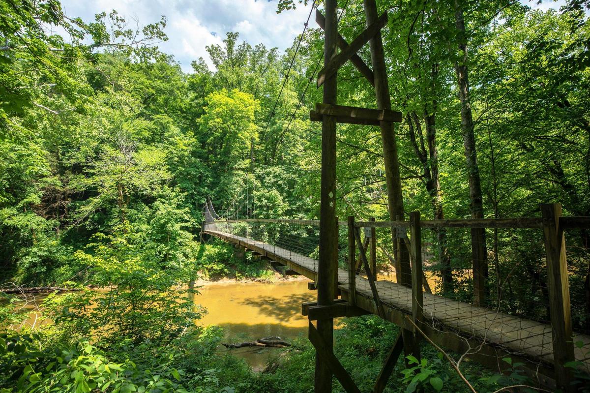 The Sheltowee Trace Suspension Bridge crosses the Red River in the Daniel Boone National Forest near Slade, Ky. Monday, May 30, 2022