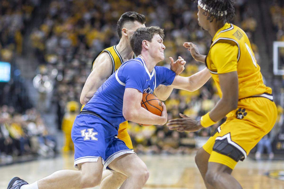 Kentucky forward Trent Noah (9) drives the ball as Missouri guards Trent Pierce (11) and Anthony Robinson II (0) defend during Saturday’s game at Mizzou Arena in Columbia, Mo.