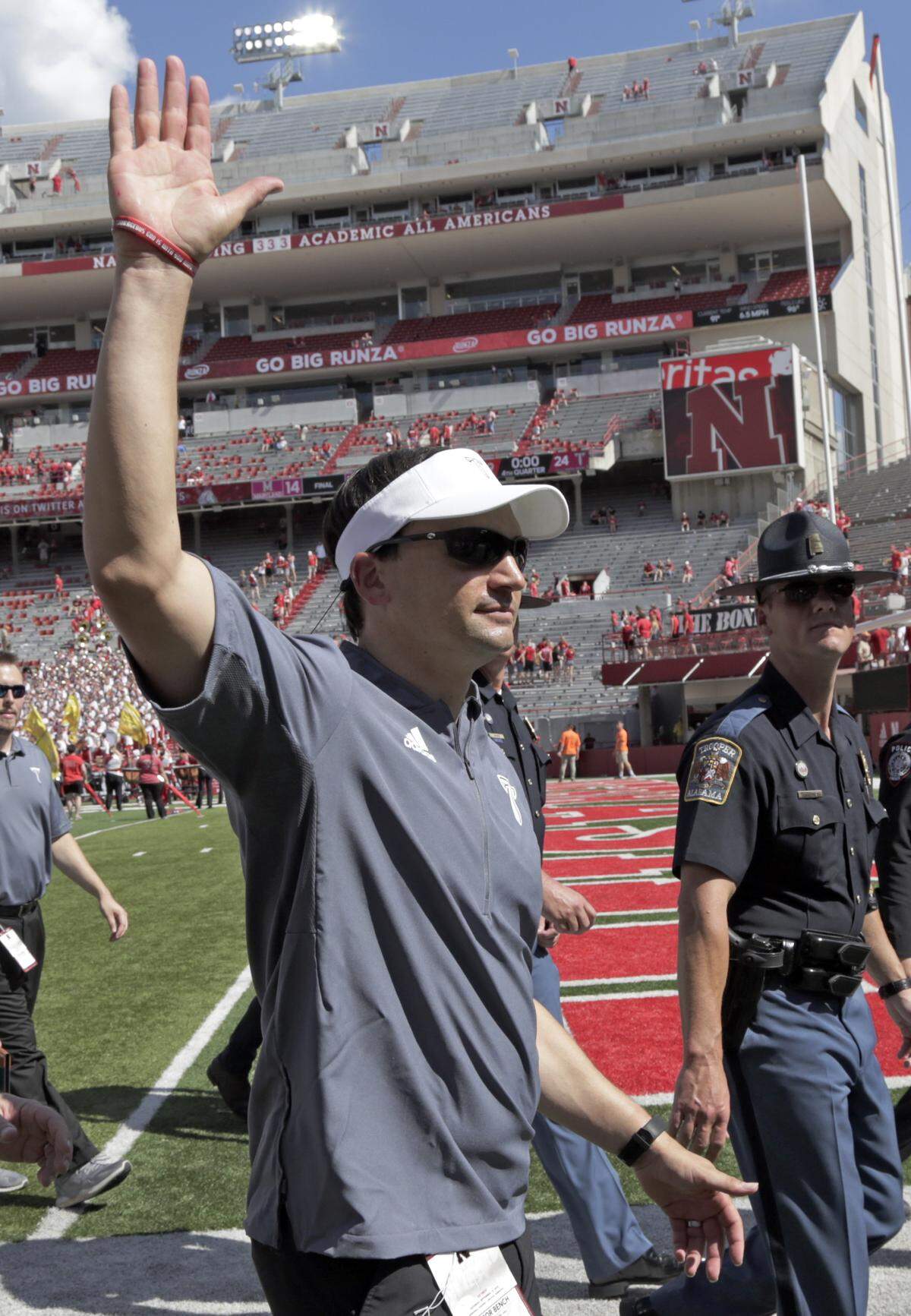 Troy head coach Neal Brown waved to fans on his way off the field after Saturday’s 24-19 victory at Nebraska.