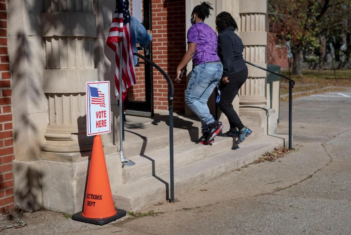 People enter the Dunbar Community Center polling location to cast their ballots in Lexington, Ky., Tuesday, November 3, 2020.
