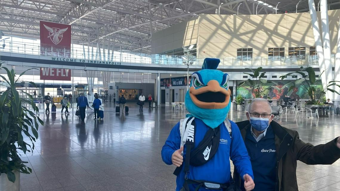Pete the Peacock touches down at the Indianapolis airport with St. Peter’s University President Eugene J. Cornacchia.