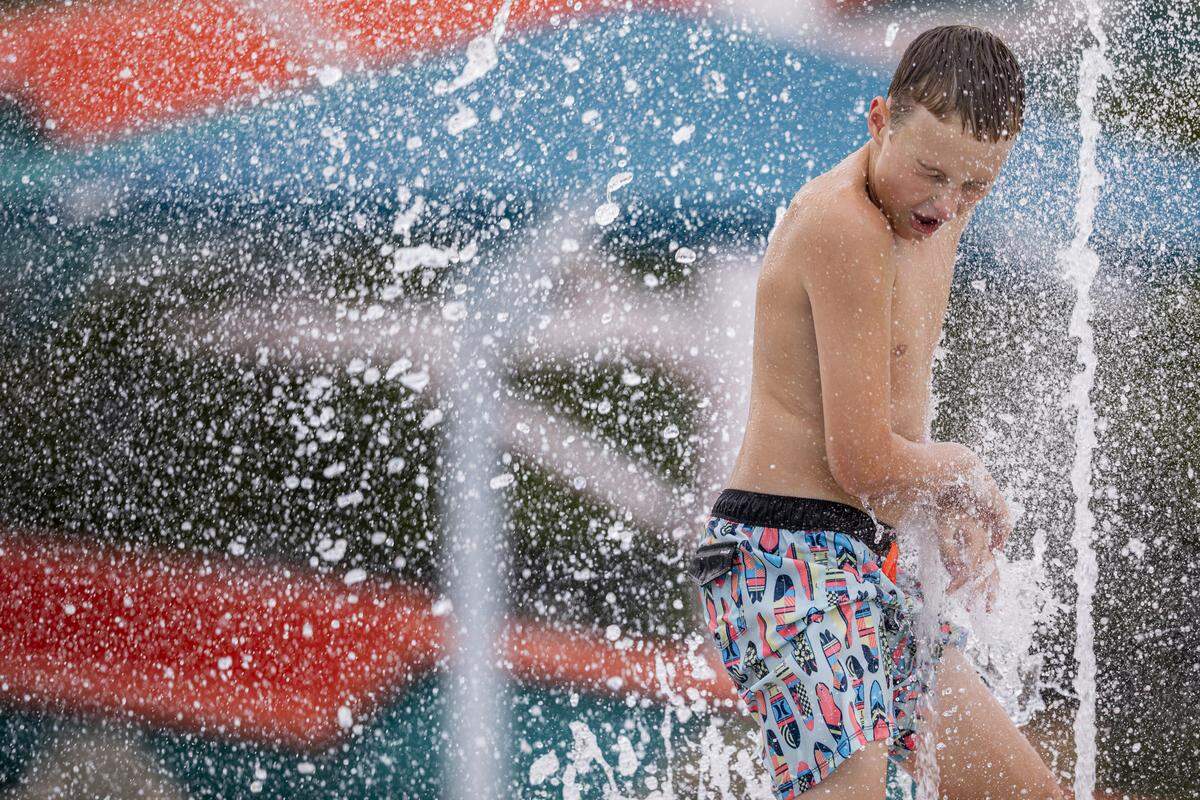 A child plays in the water during the Douglass Aquatic Center opening on Thursday, Aug. 21, 2025, at Douglass Park in Lexington, Ky. 