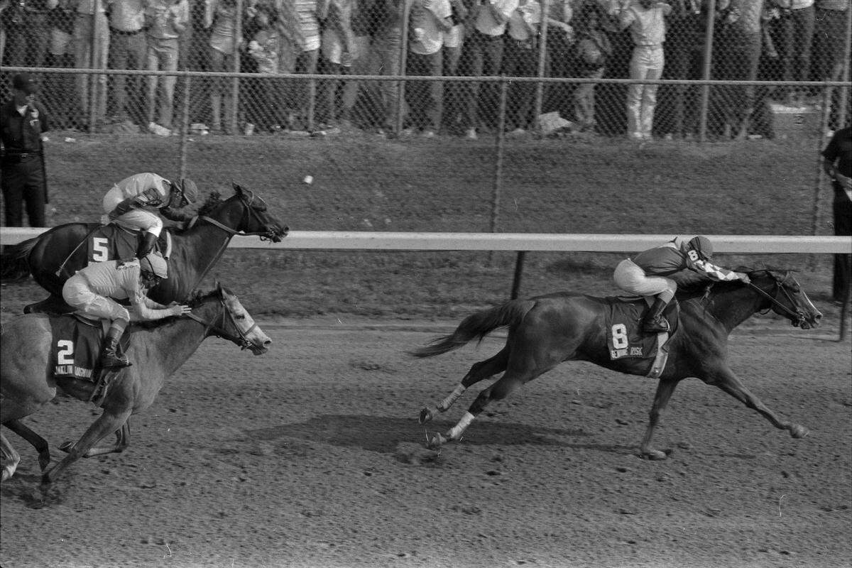 Filly Genuine Risk, with Jacinto Vasquez up, pulls away to win the 106th running of the Kentucky Derby in 1980.