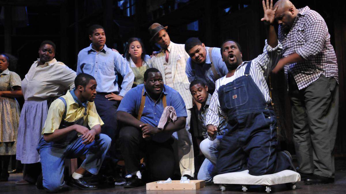 Porgy (Kenneth Overton, on the cart) defends the honor of Bess, who has just entered Catfish Row and made a spectacle of herself. The University of Kentucky Opera Theatre presents George Gershwin's "Porgy and Bess," Jan. 28, 29 and Feb. 4-6 in the Singletary Center for the Arts Concert Hall at the University of Kentucky in Lexington, Ky. This photo was taken at a dress rehearsal Jan. 26, 2011. Photo by Rich Copley | Lexington Herald-Leader