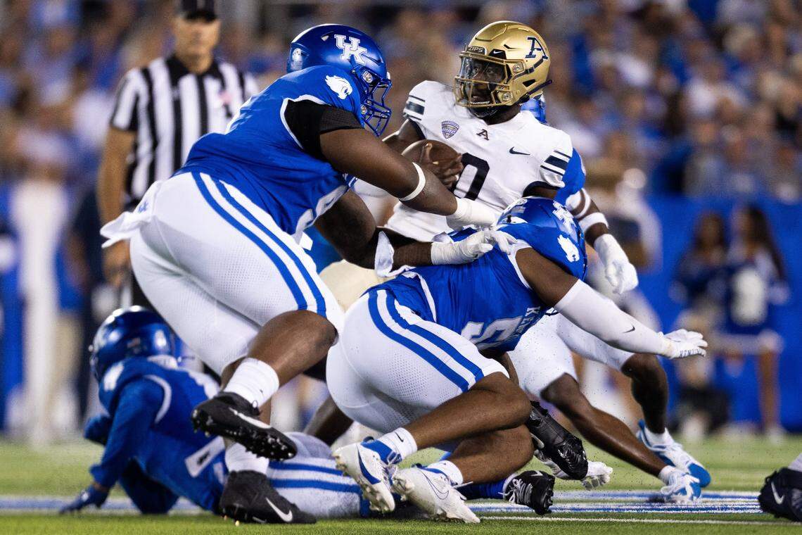 Akron quarterback DJ Irons (0) is tackled by the Kentucky defense at Kroger Field on Saturday.