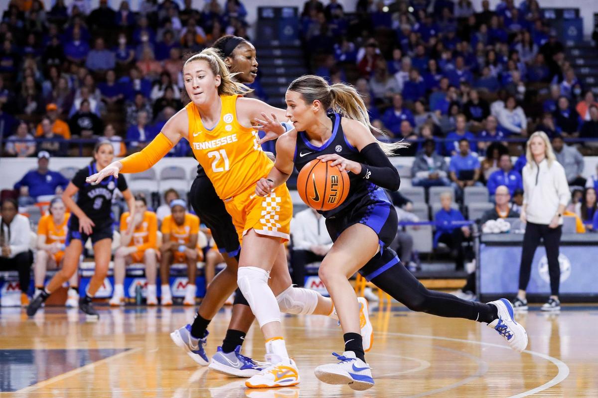 Kentucky guard Maddie Scherr (22) drives to the basket around Tennessee forward Tess Darby (21) during Sunday’s game at Memorial Coliseum. Scherr scored a career-high 27 points.