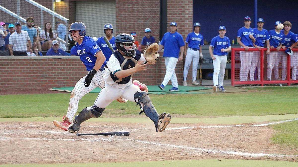 Lexington Catholic catcher Owen Jenkins scores the go-ahead run in the bottom of the sixth inning .
