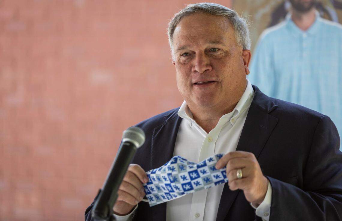 Kentucky Senate President Robert Stivers holds up a facemask with the University of Kentucky logo on it during a visit to the Freedom House to celebrate the Volunteers of America receiving a $2.6 million grant from SAMHSA to assist with recovery treatment for pregnant women and mothers in Manchester, Ky., Tuesday, August 18, 2020.