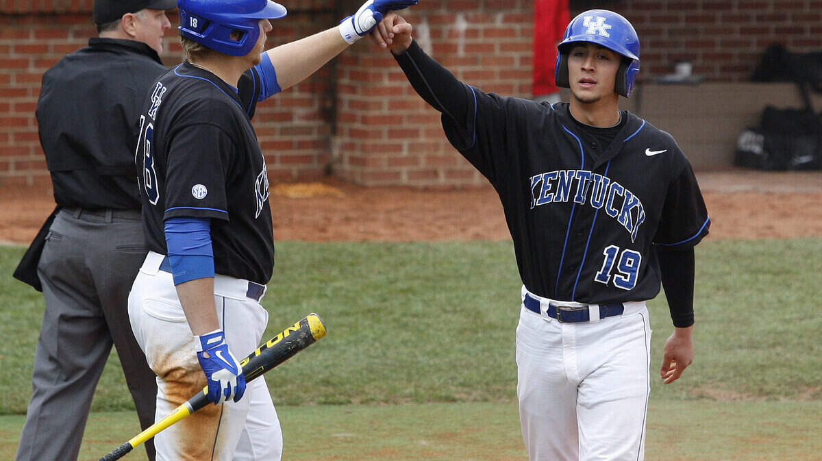 Austin Cousino is congratulated by A. J. Reed, left, after scoring on the single by Zac Sellers in the third inning against Georgia at Cliff Hagan Stadium in Lexington, KY, Sunday, March 31, 2013. Photo by Matt Goins
